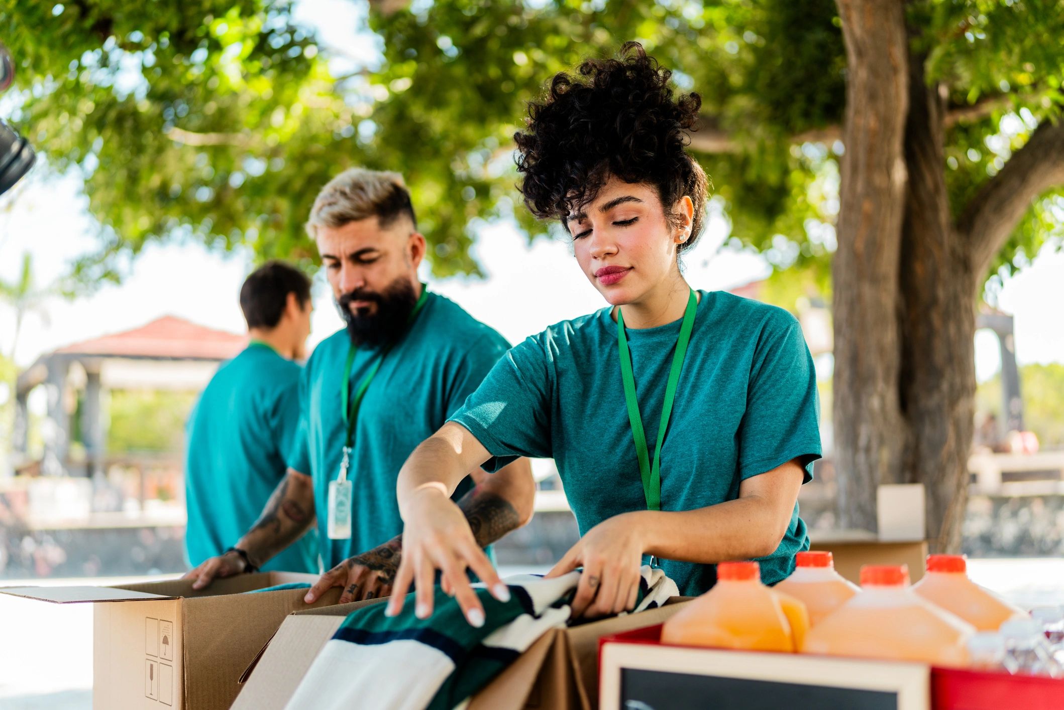 Volunteer coordinator organizing donation boxes outdoors